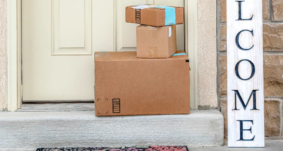 Boxes by the door of a residence with a welcome sign in Tuscaloosa